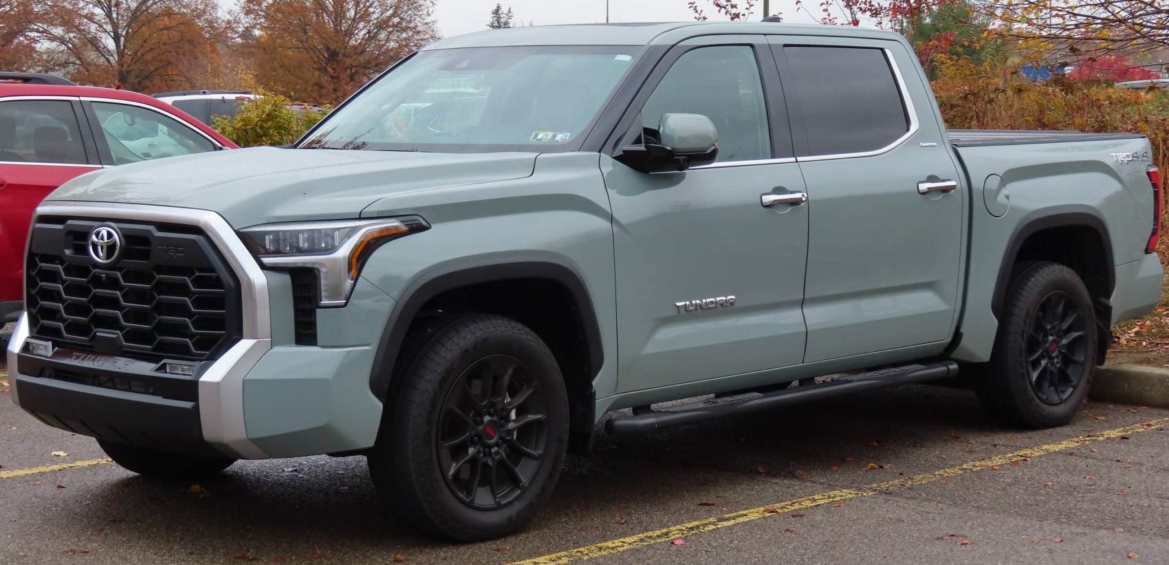 Aggressive front grille and black wheels with crew cab short bed side profile