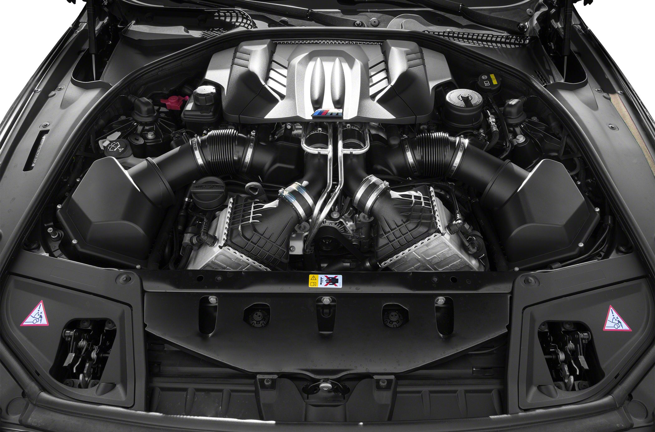 Close-up of a high-performance V8 engine with twin air intakes and M branding.