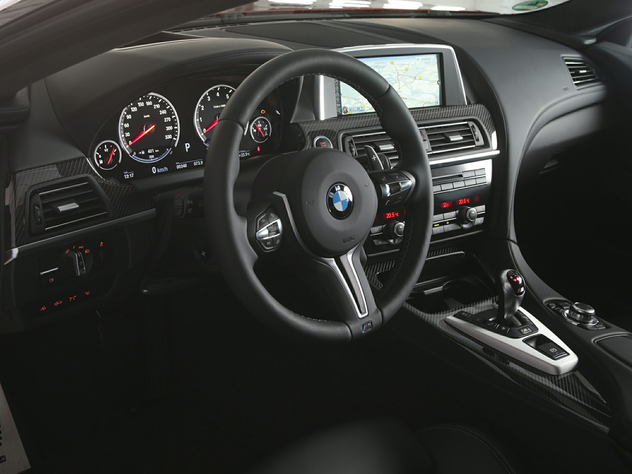 Steering wheel, digital instrument cluster, infotainment screen, carbon fiber trim