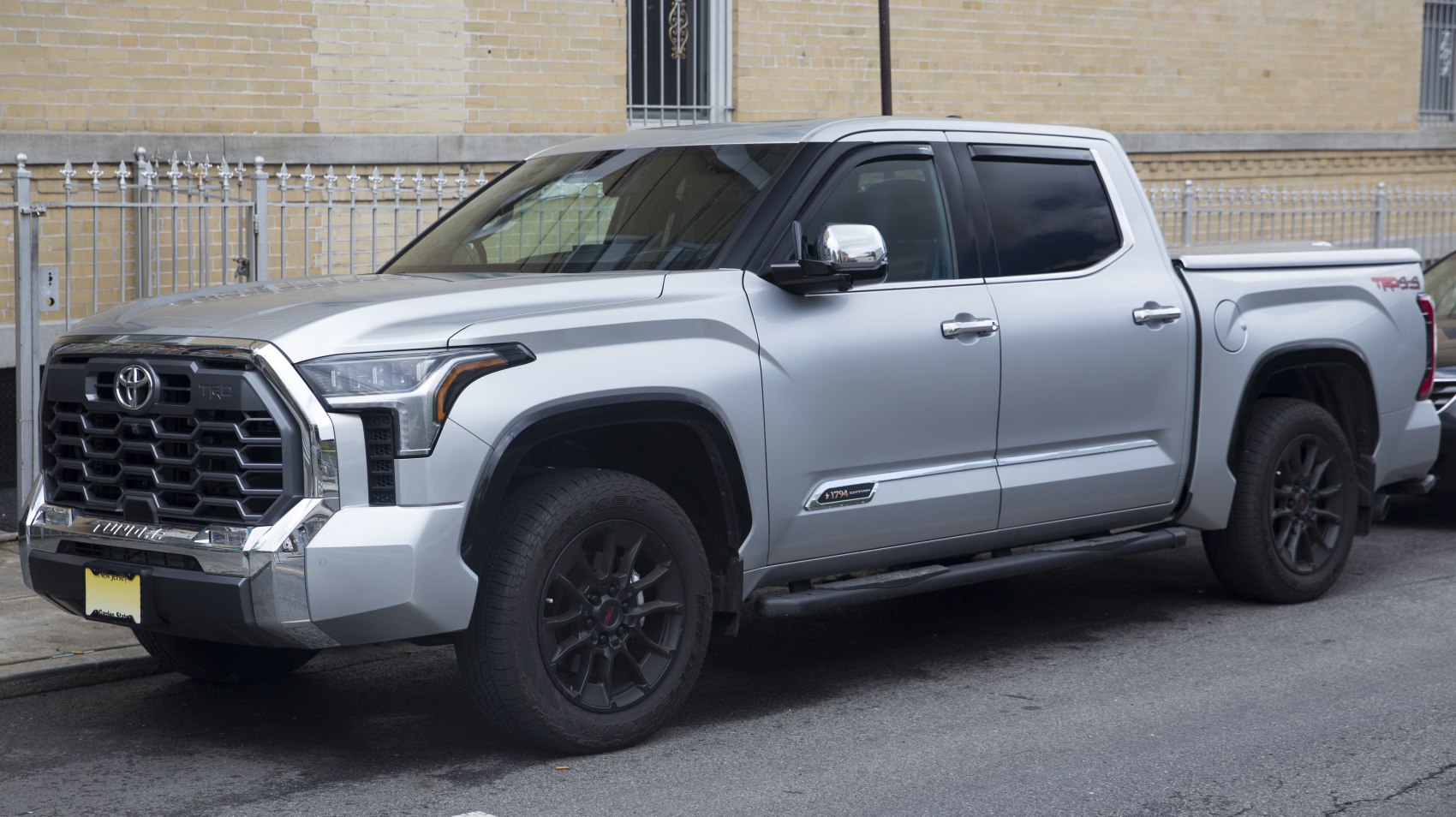Silver pickup with bold grille, LED headlights, and CrewMax doors