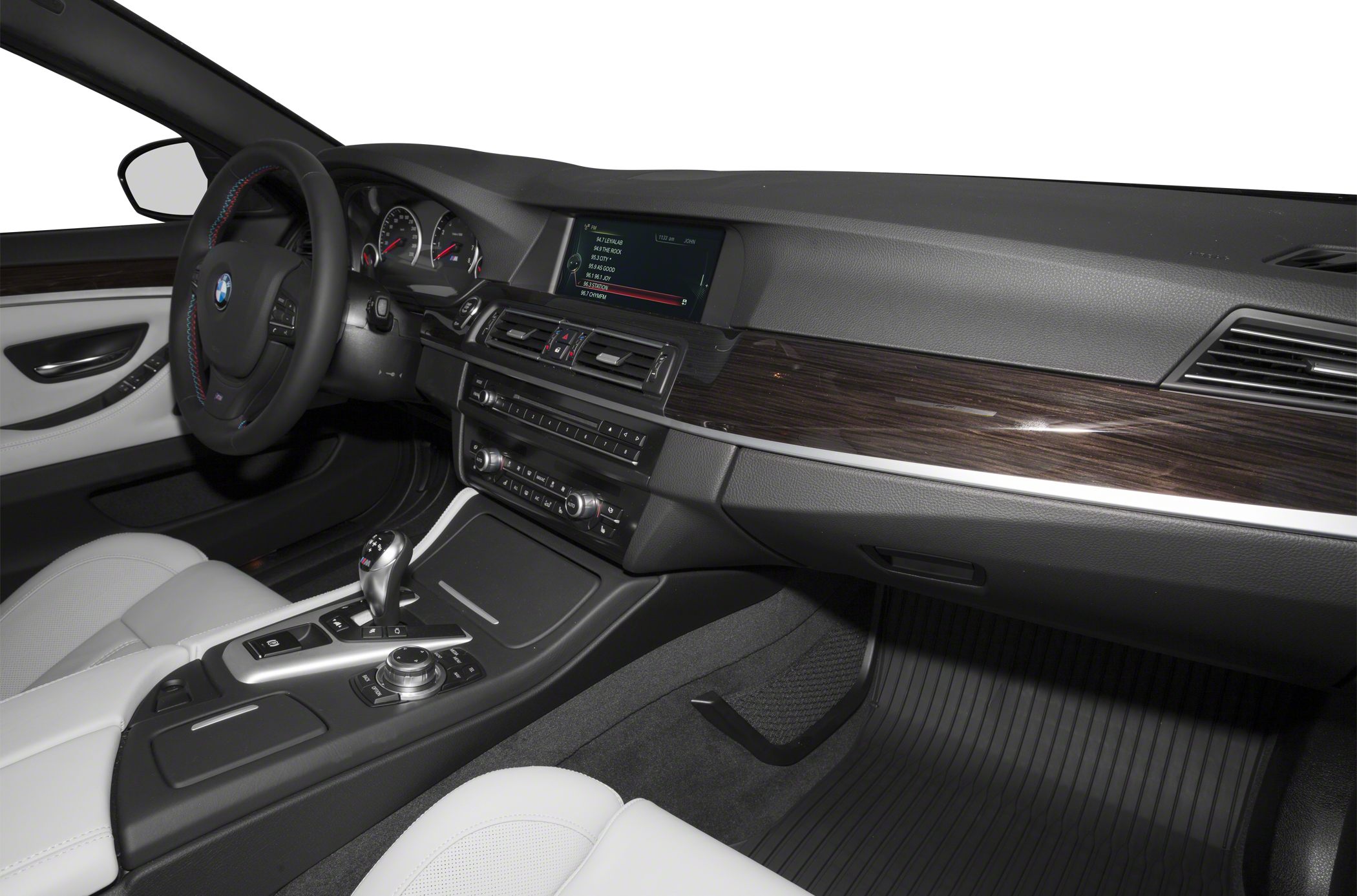 Luxury car interior with dashboard, infotainment screen, steering wheel, and center console.