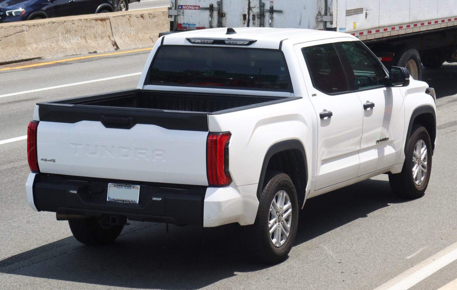 Rear view of pickup with open short bed and vertical taillights
