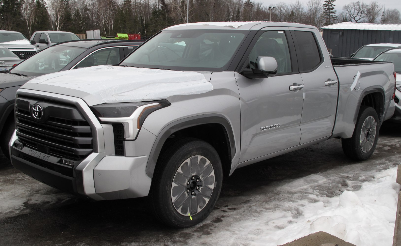Modern pickup truck with double cab, standard bed, and large grille