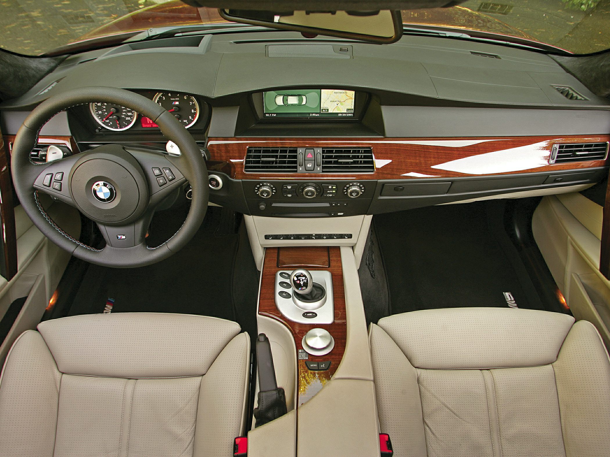 Luxury dashboard and steering wheel with wood trim and navigation display