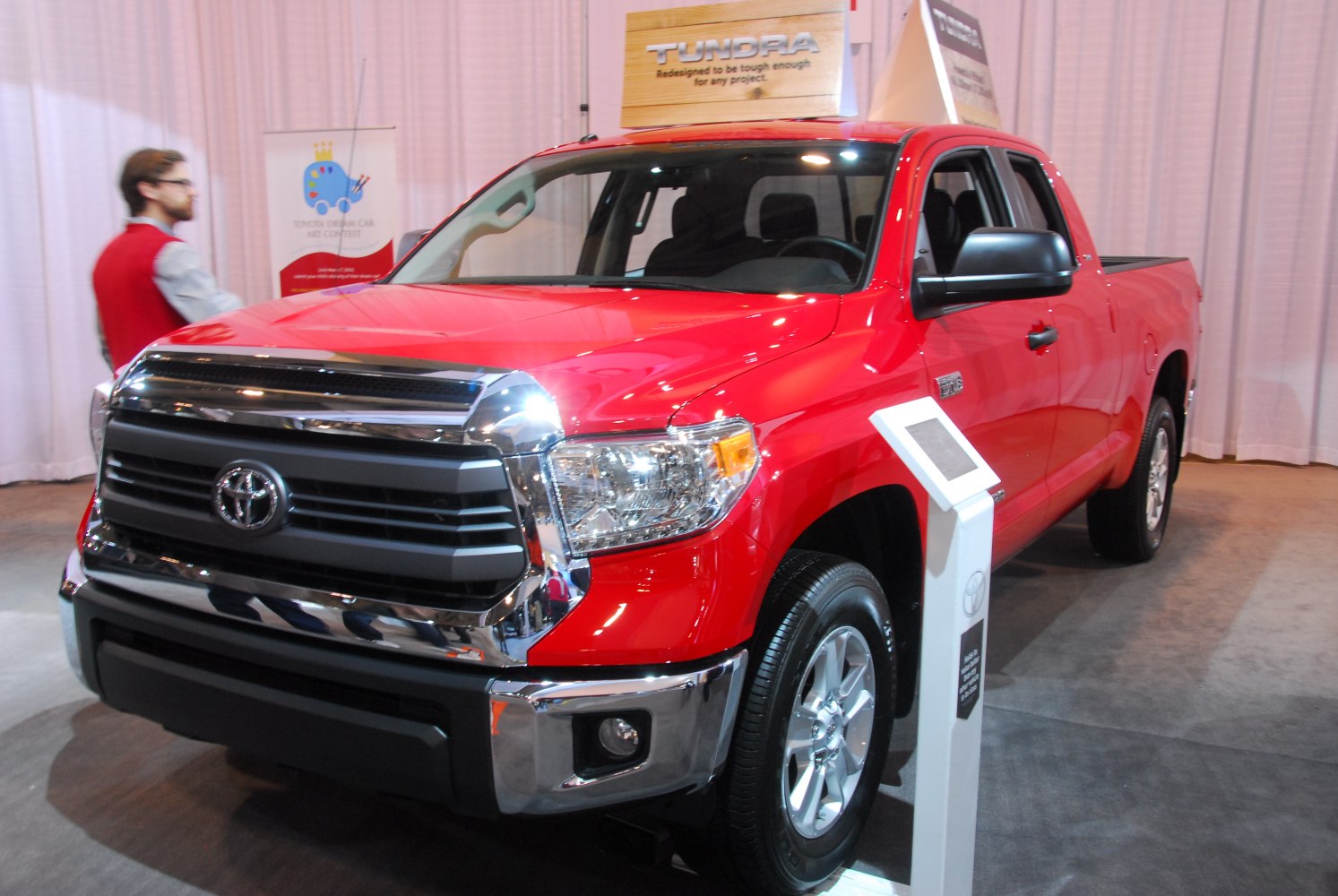 Red pickup truck front side with chrome grille and headlights