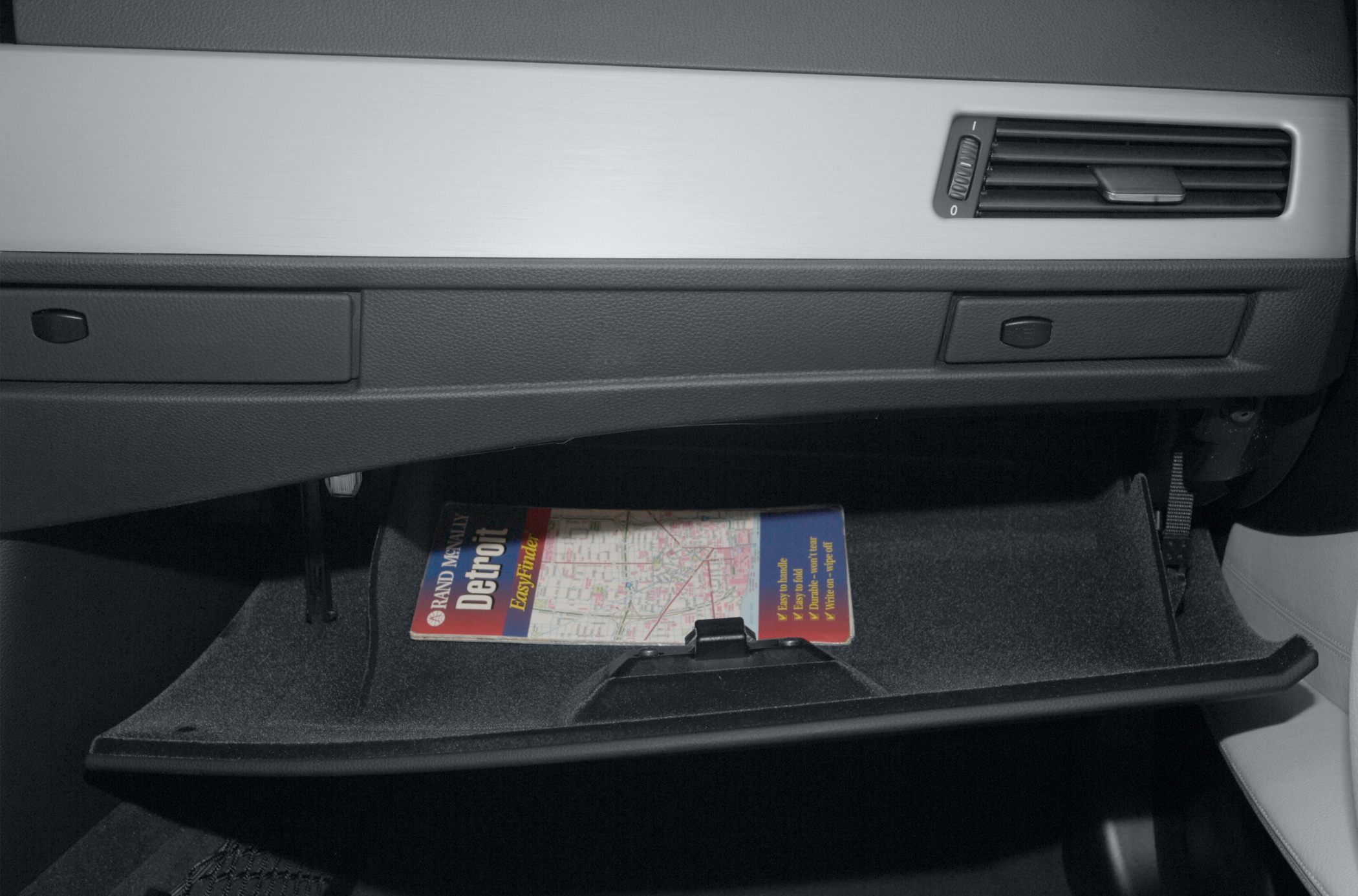Open glove compartment with a Detroit map inside