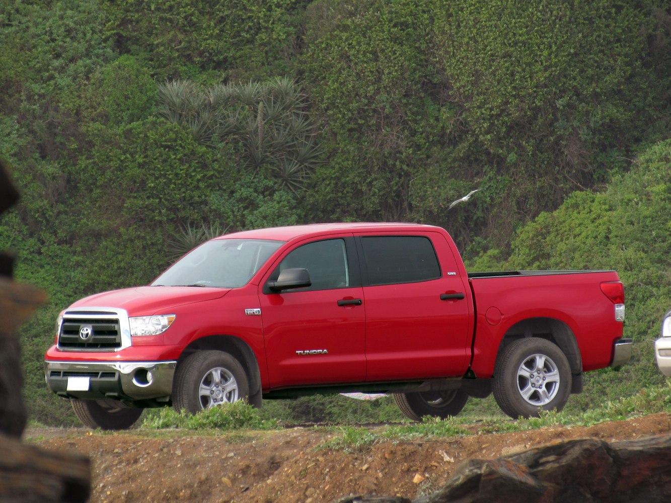 Red pickup with double cab, chrome grille and rugged tires