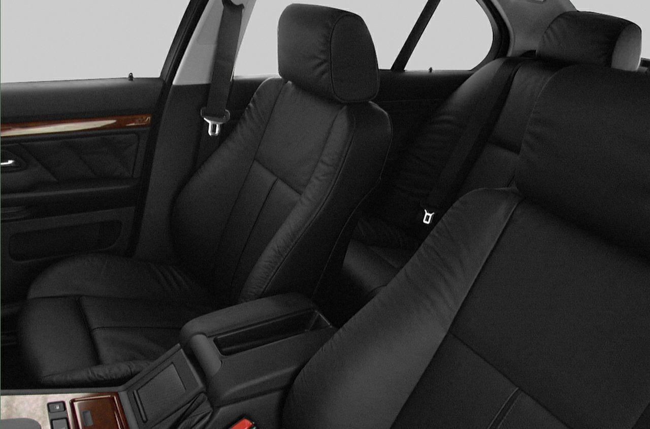 Black leather seats with wood trim and center console interior elements