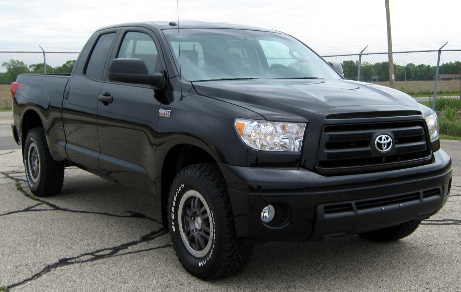 Black double cab pickup with off-road tires and rugged front design
