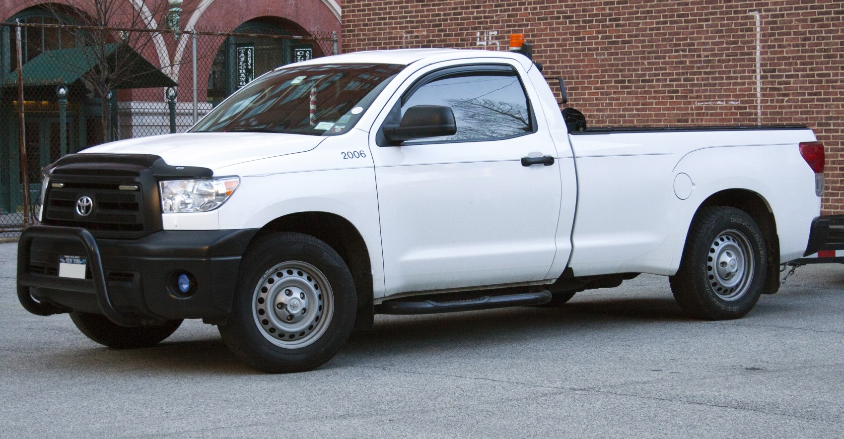 Side view of pickup truck with regular cab and long bed.