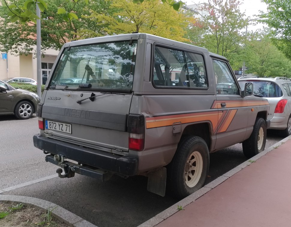Rear view of vintage SUV with distinctive striped decals and towing hitch