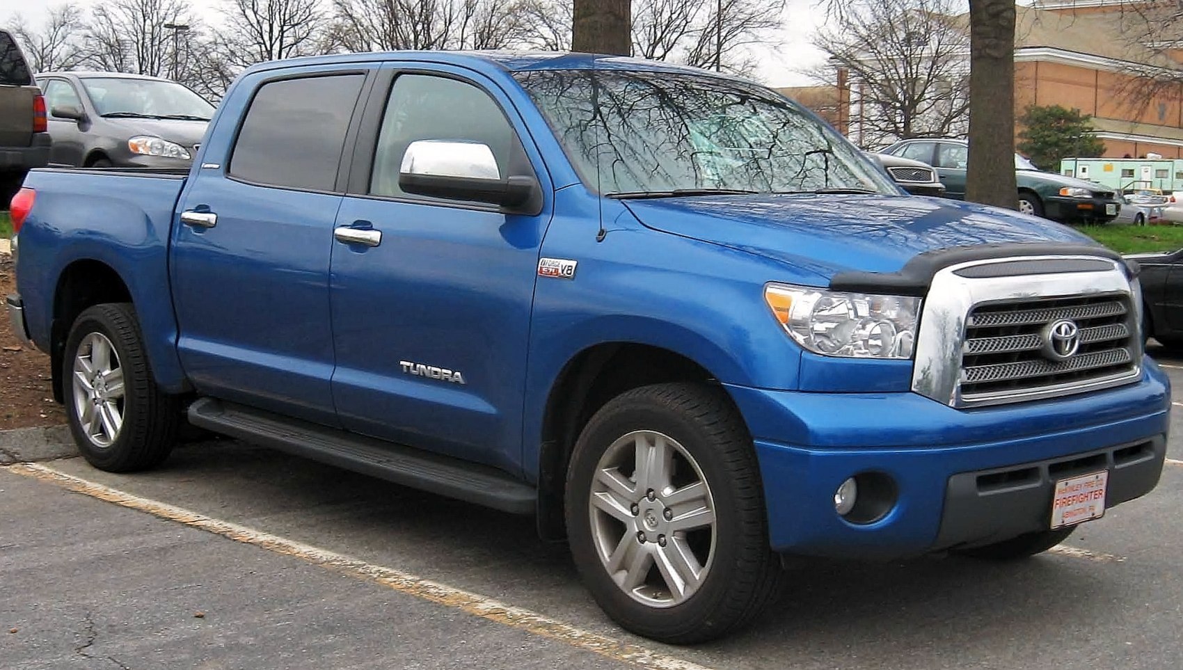 Blue full-size pickup truck with CrewMax cabin and prominent grille