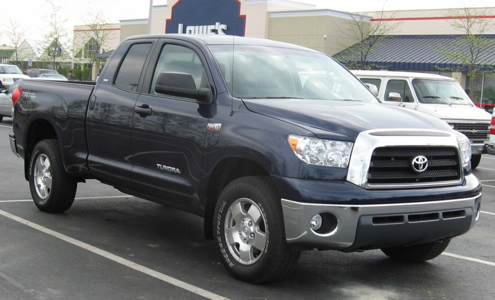 Double cab pickup truck with chrome grille, front-side angle