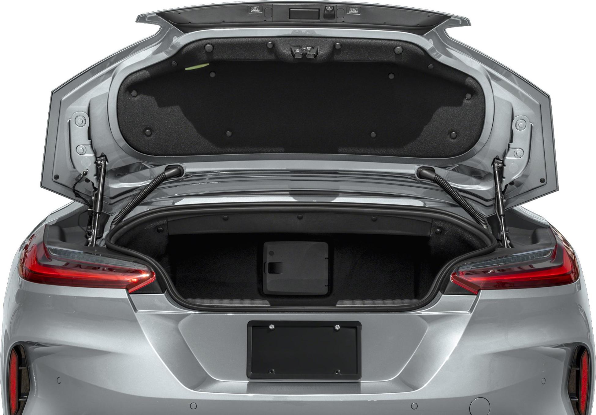 Rear trunk open with visible spacious storage compartment and modern taillights