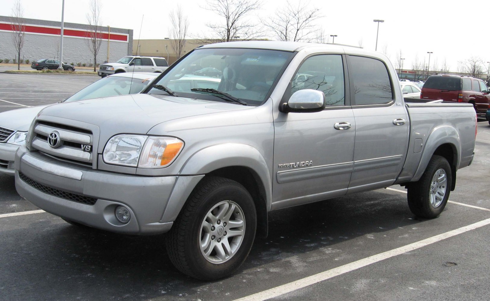 Front side view of a silver double cab pickup with V8 badge and updated grille