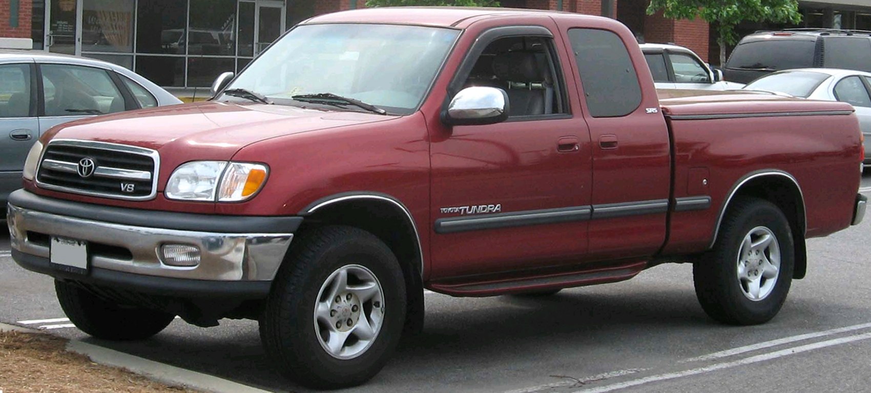 Extended cab pickup truck with covered bed and chrome bumper