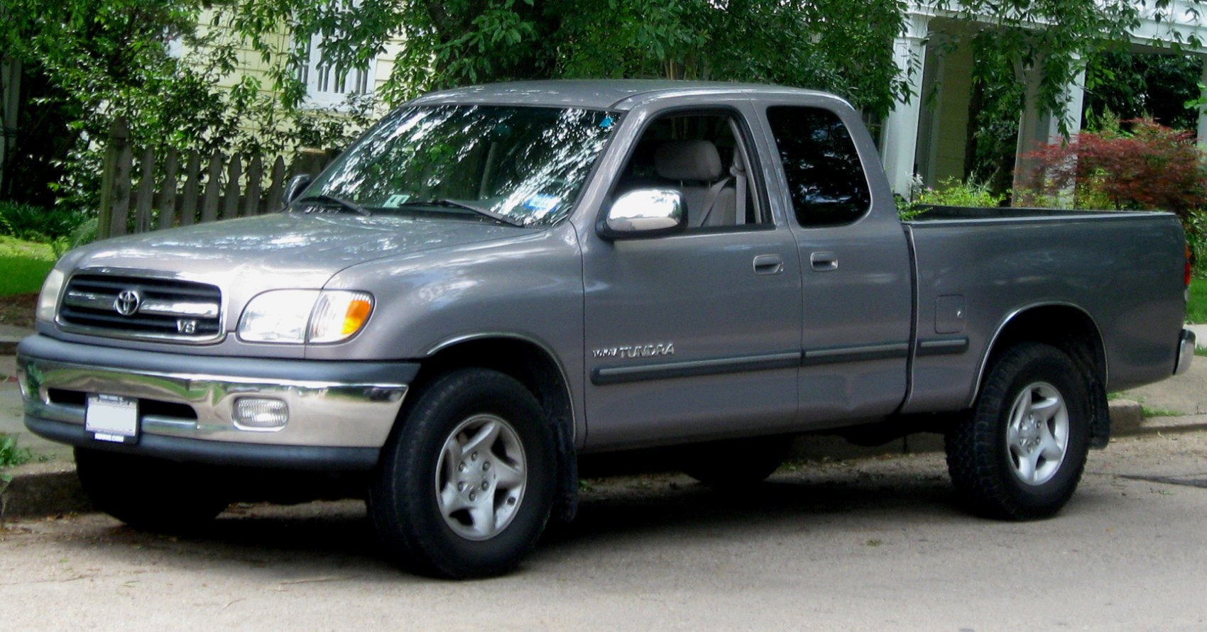 Silver extended cab pickup with V8 engine and classic design