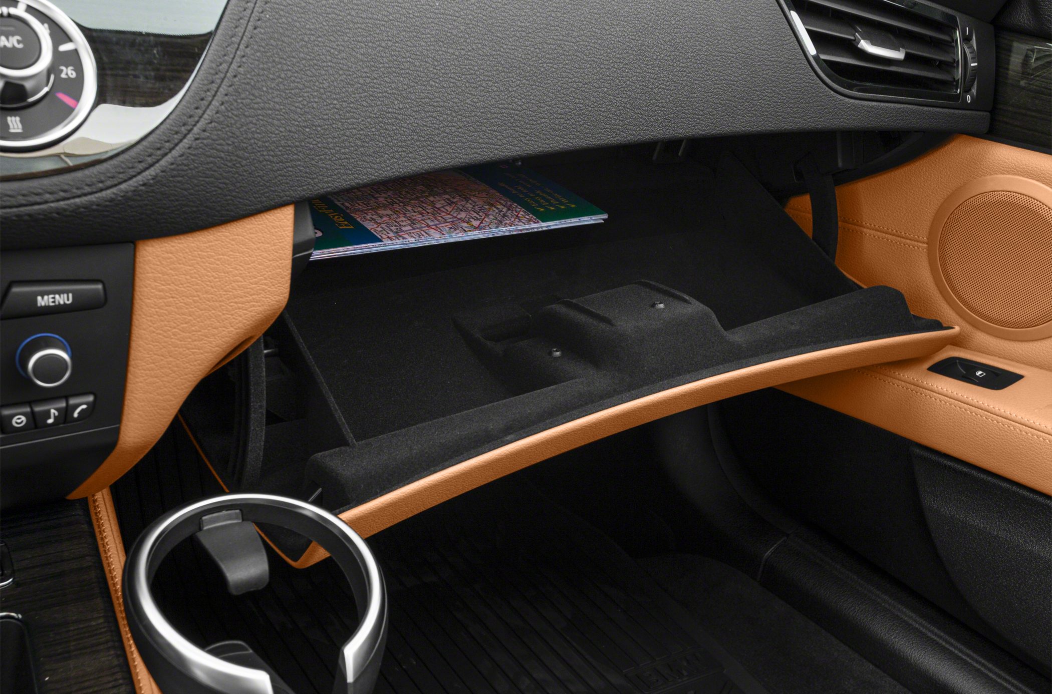 Open glovebox with beige and black interior trim