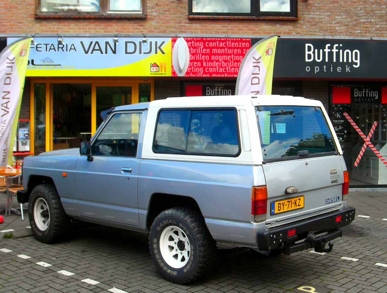 Off-road SUV with white hardtop and rugged tires