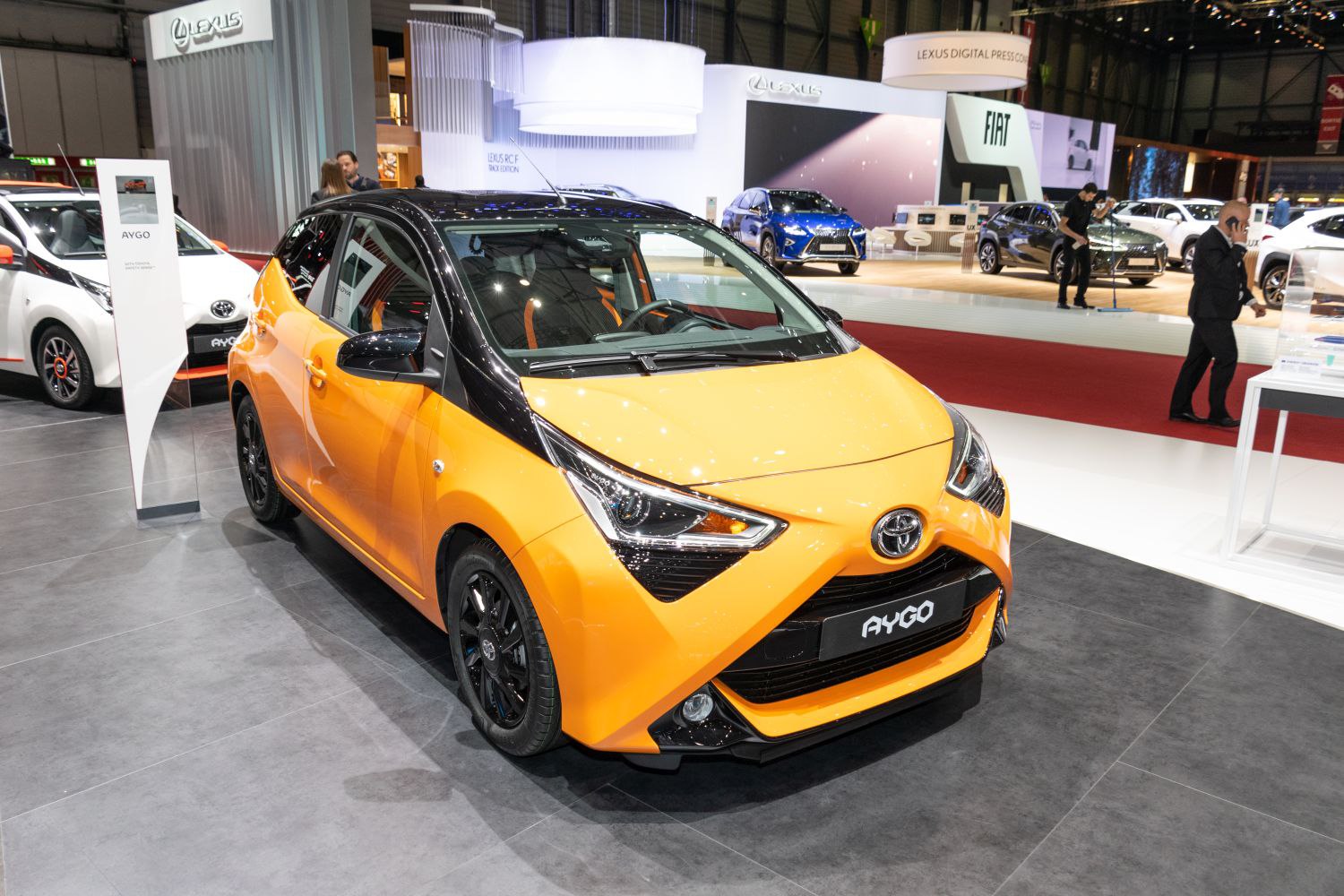 Bright-colored compact hatchback with angular LED headlights and black contrast accents.