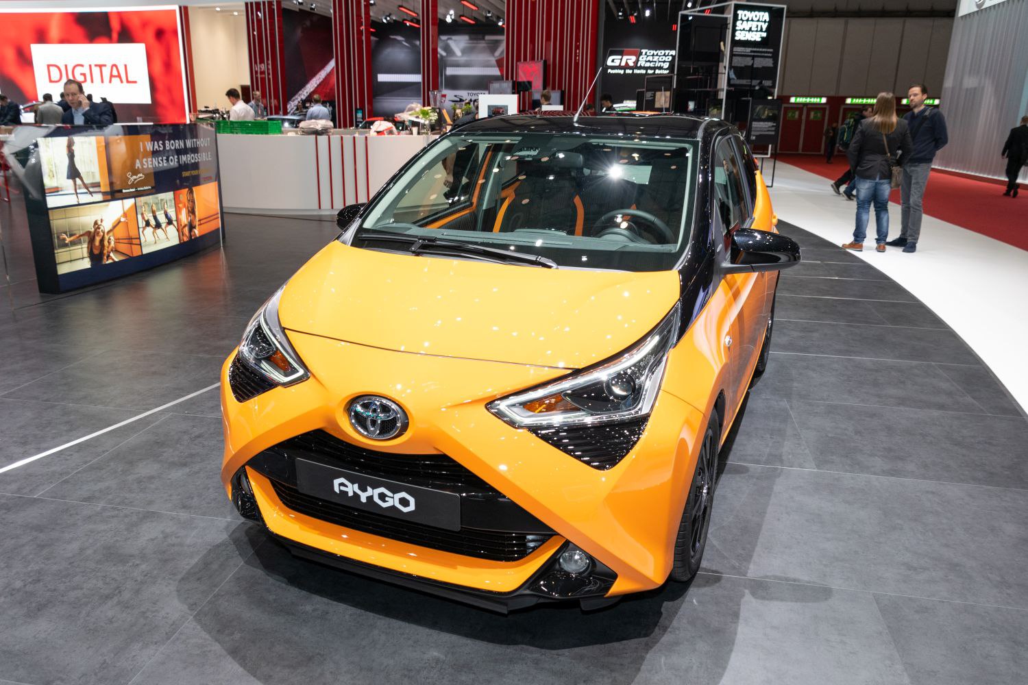 Compact hatchback with distinctive X-shaped front design and sporty black-orange color scheme