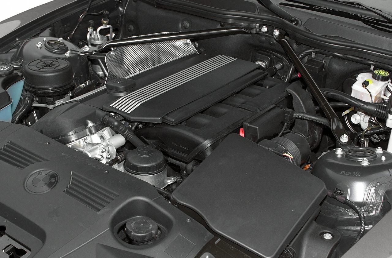 Clean BMW inline engine bay with air intake and reinforced strut bar