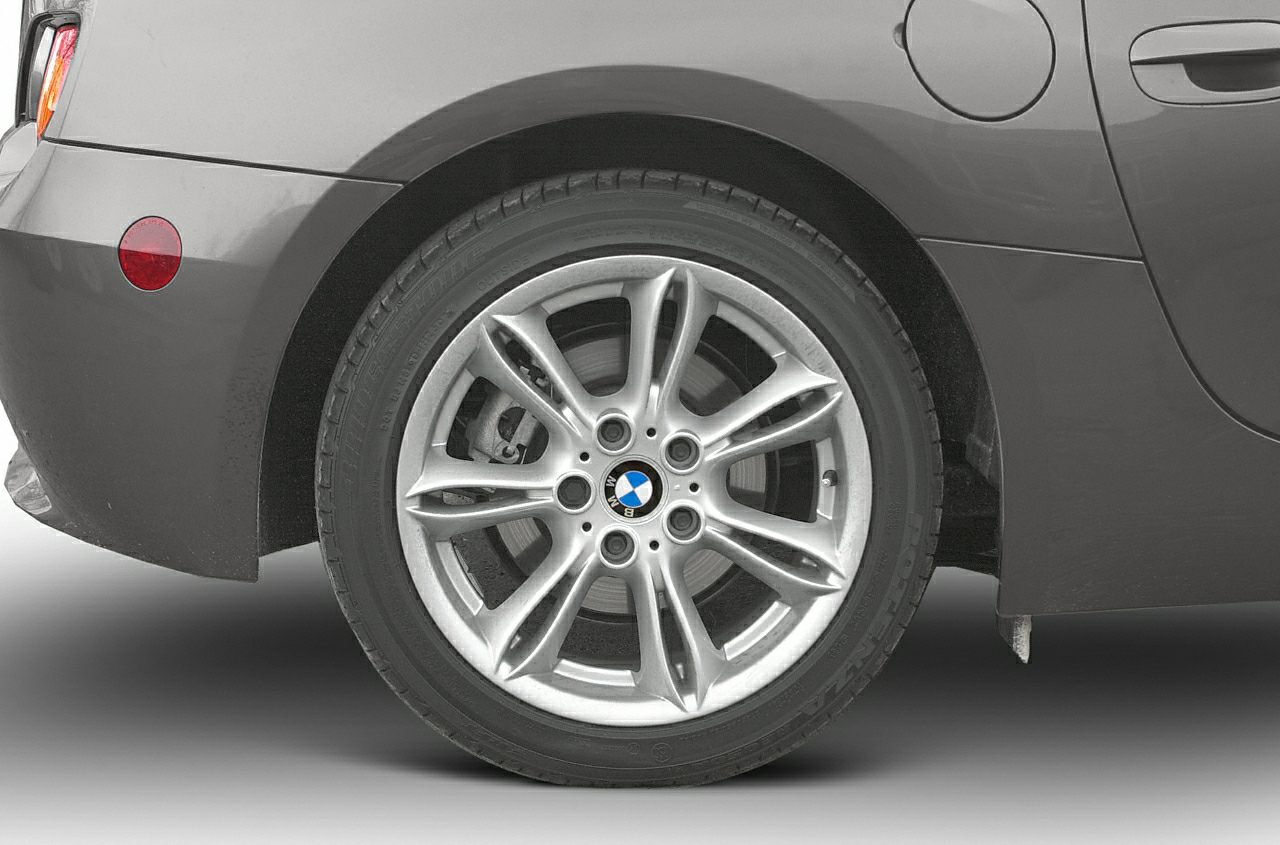 Close-up of alloy wheel and rear side of the car