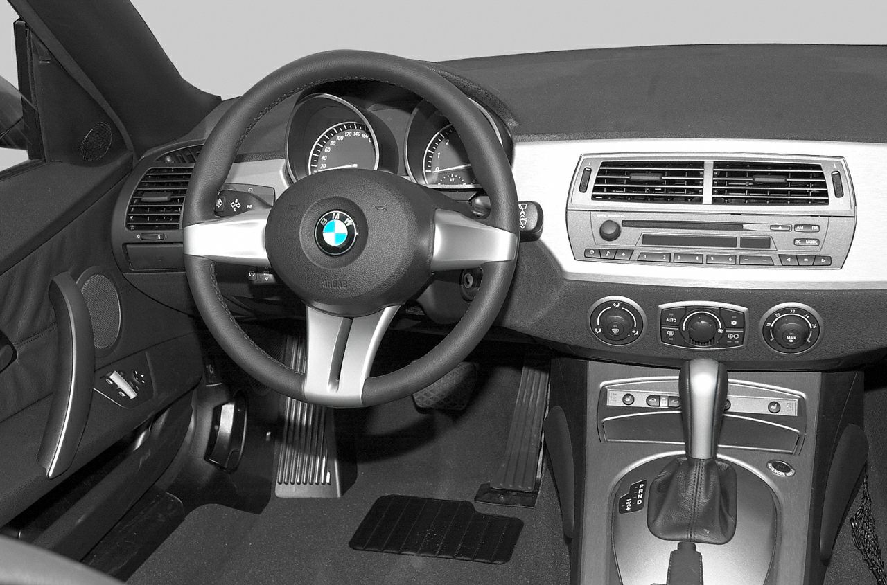 Interior dashboard view with steering wheel and gear shift