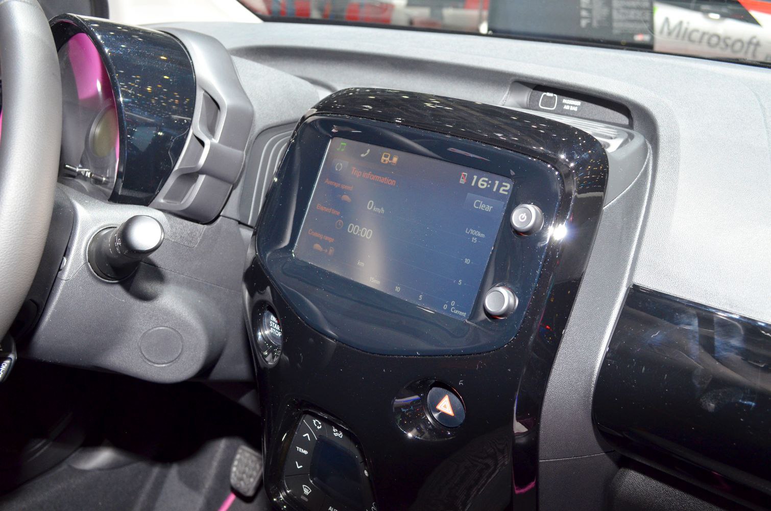 Touchscreen infotainment system with control buttons and dashboard elements