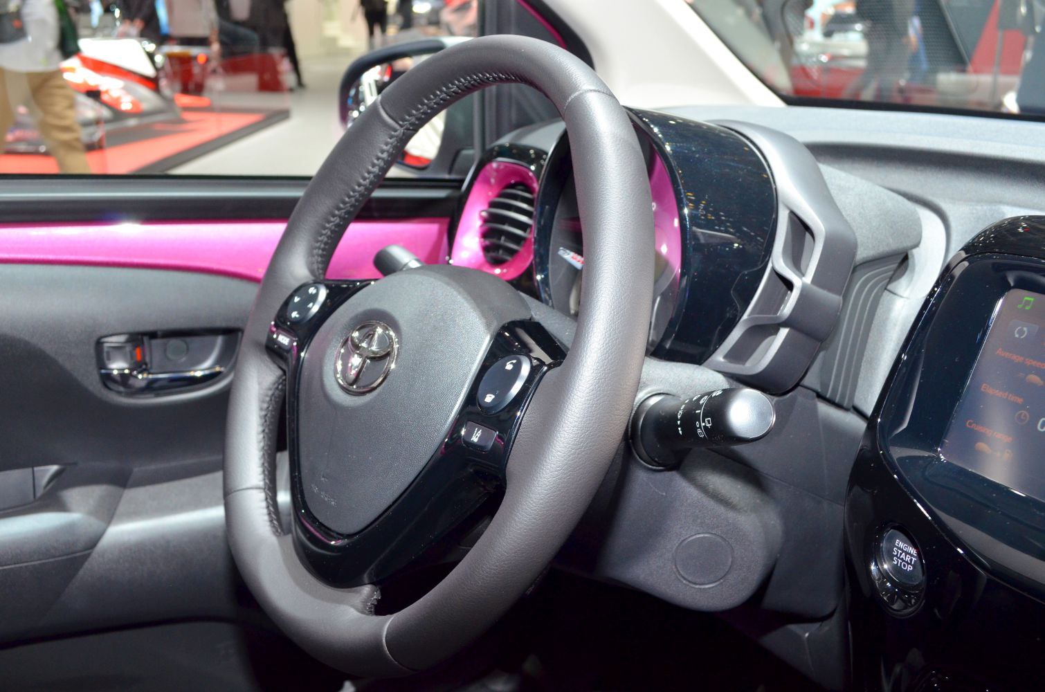 Steering wheel, dashboard, instrument cluster, and push start button with vibrant interior trim