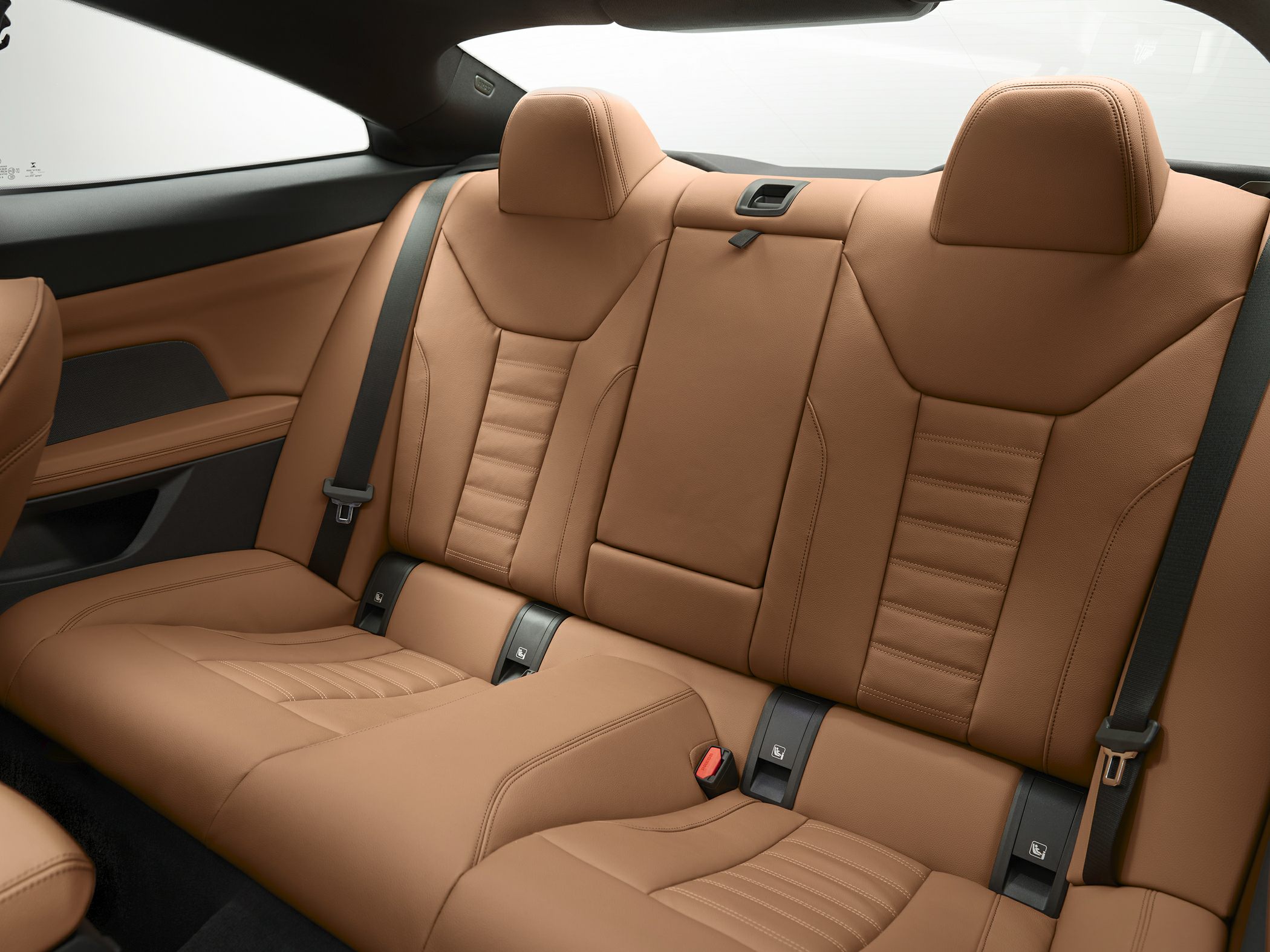 Premium brown leather rear seats with seatbelts and modern stitching
