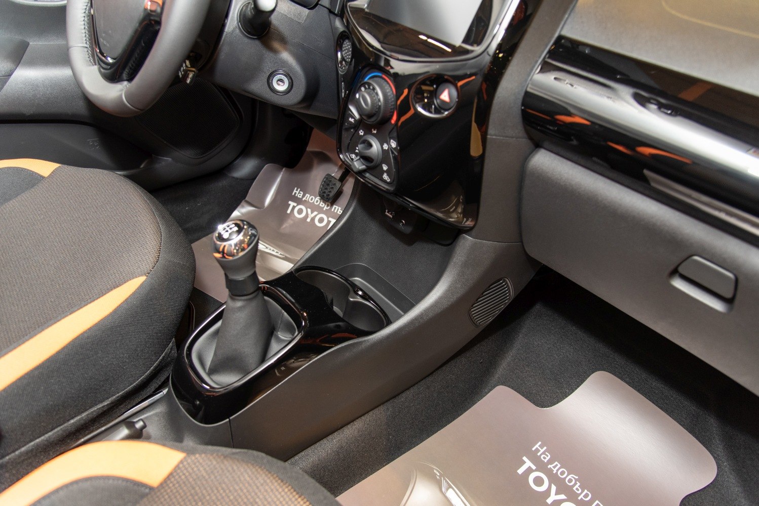 Manual gear shift and center console in compact car interior