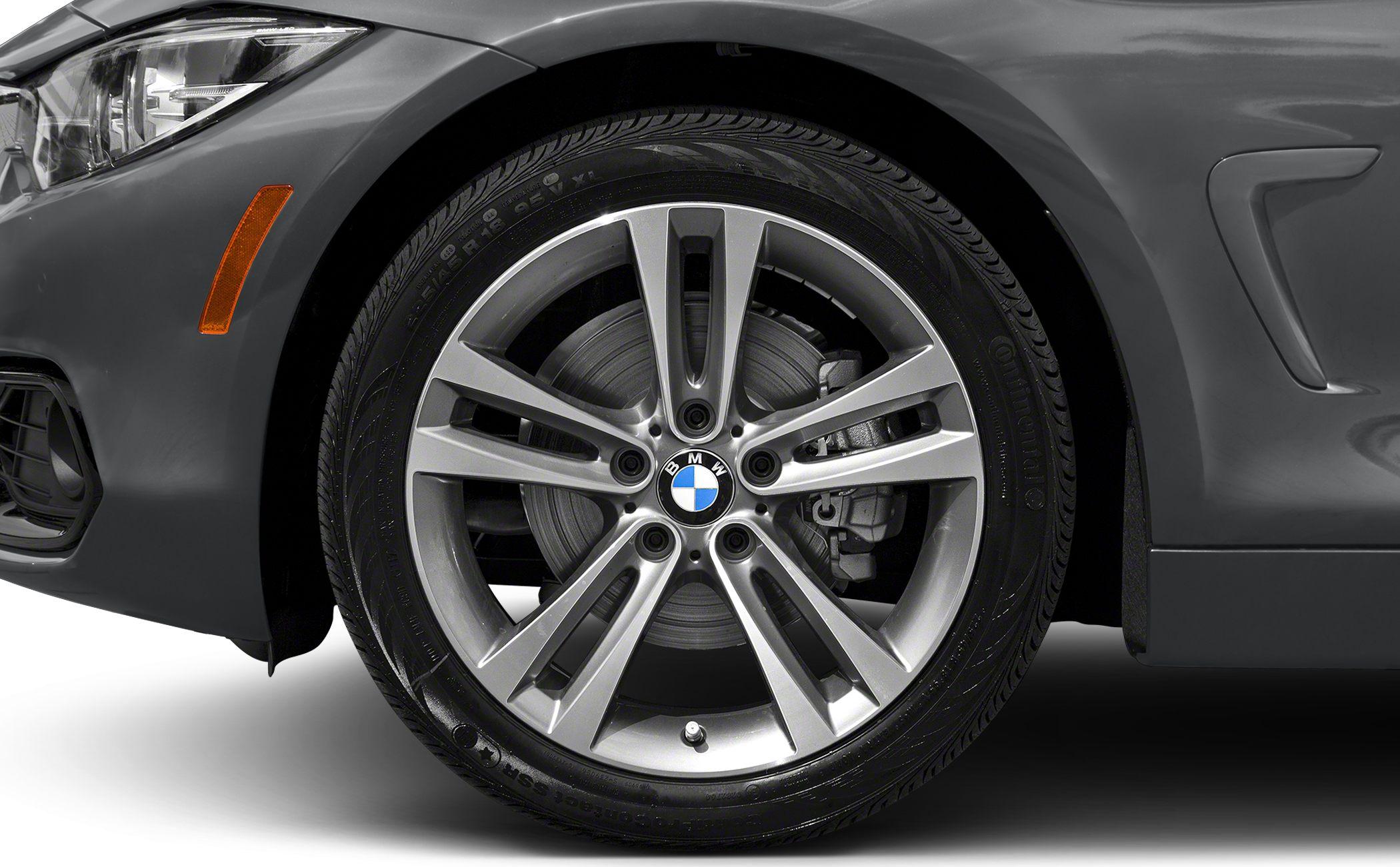 Close-up of alloy wheel and front fender with side marker light