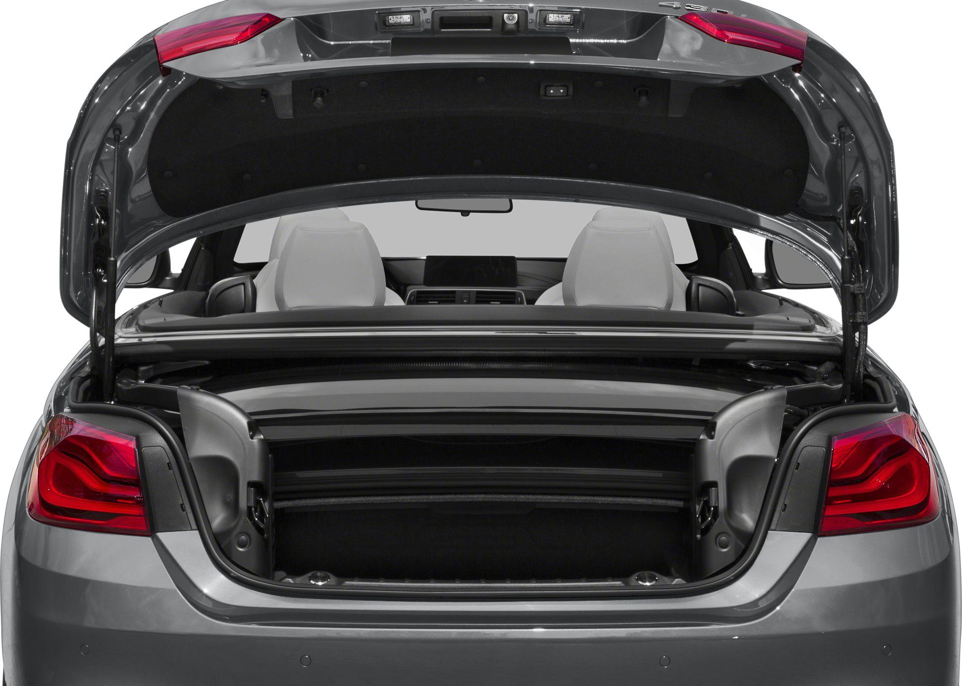 Rear trunk open showcasing convertible top mechanism and back seats