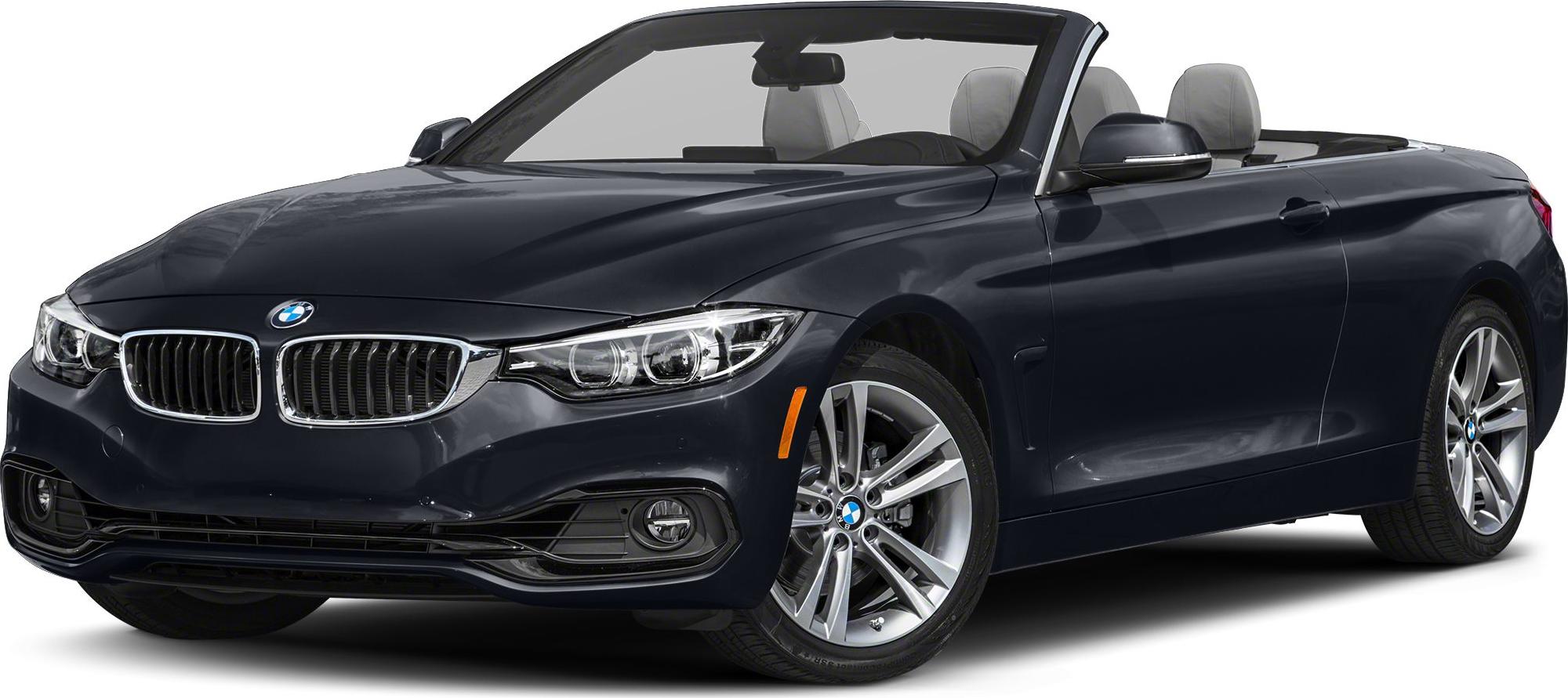 Convertible car with open roof, distinctive front grille, headlights, and alloy wheels