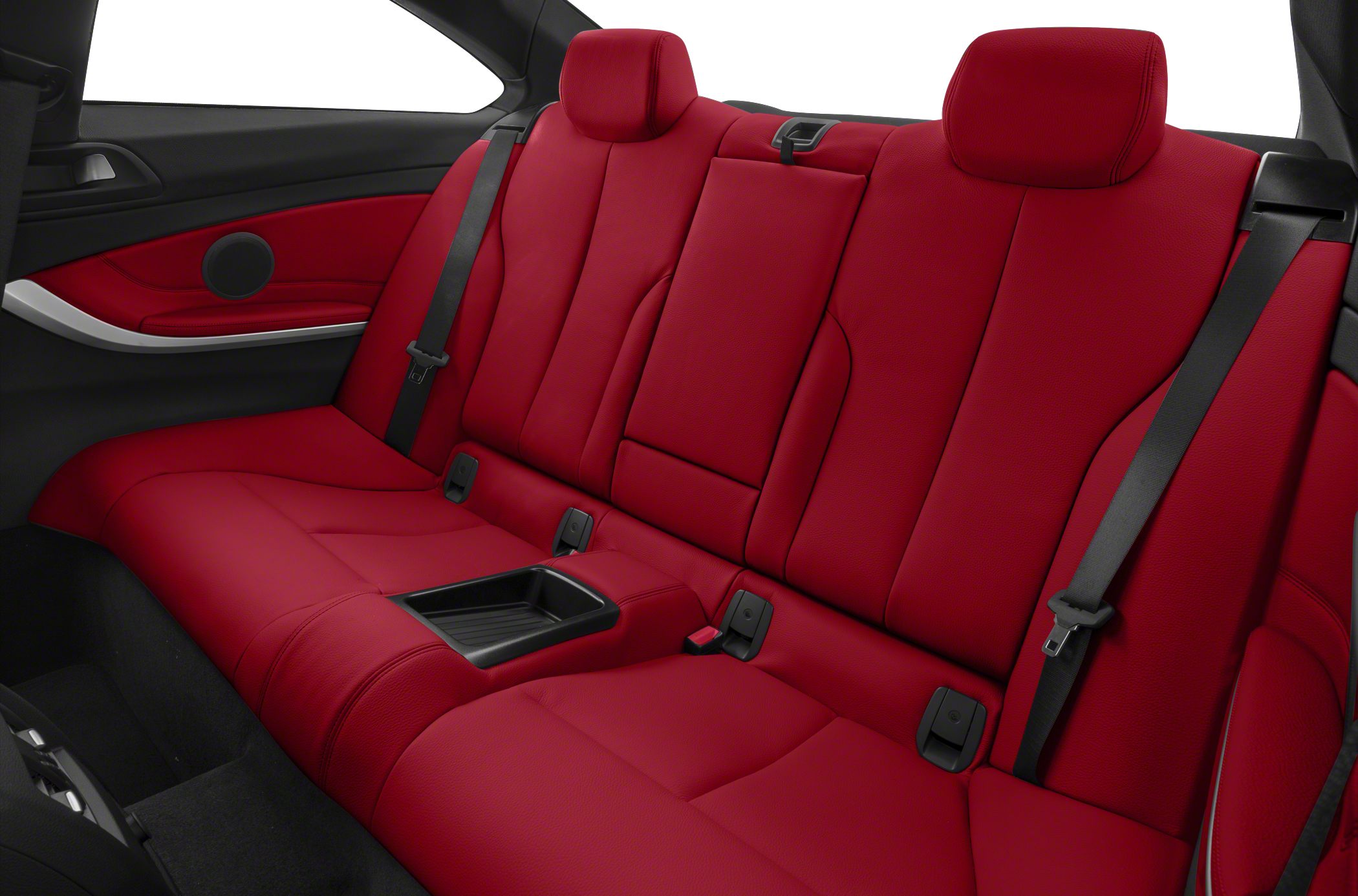 Red rear seats with seat belts and armrest in a coupe interior