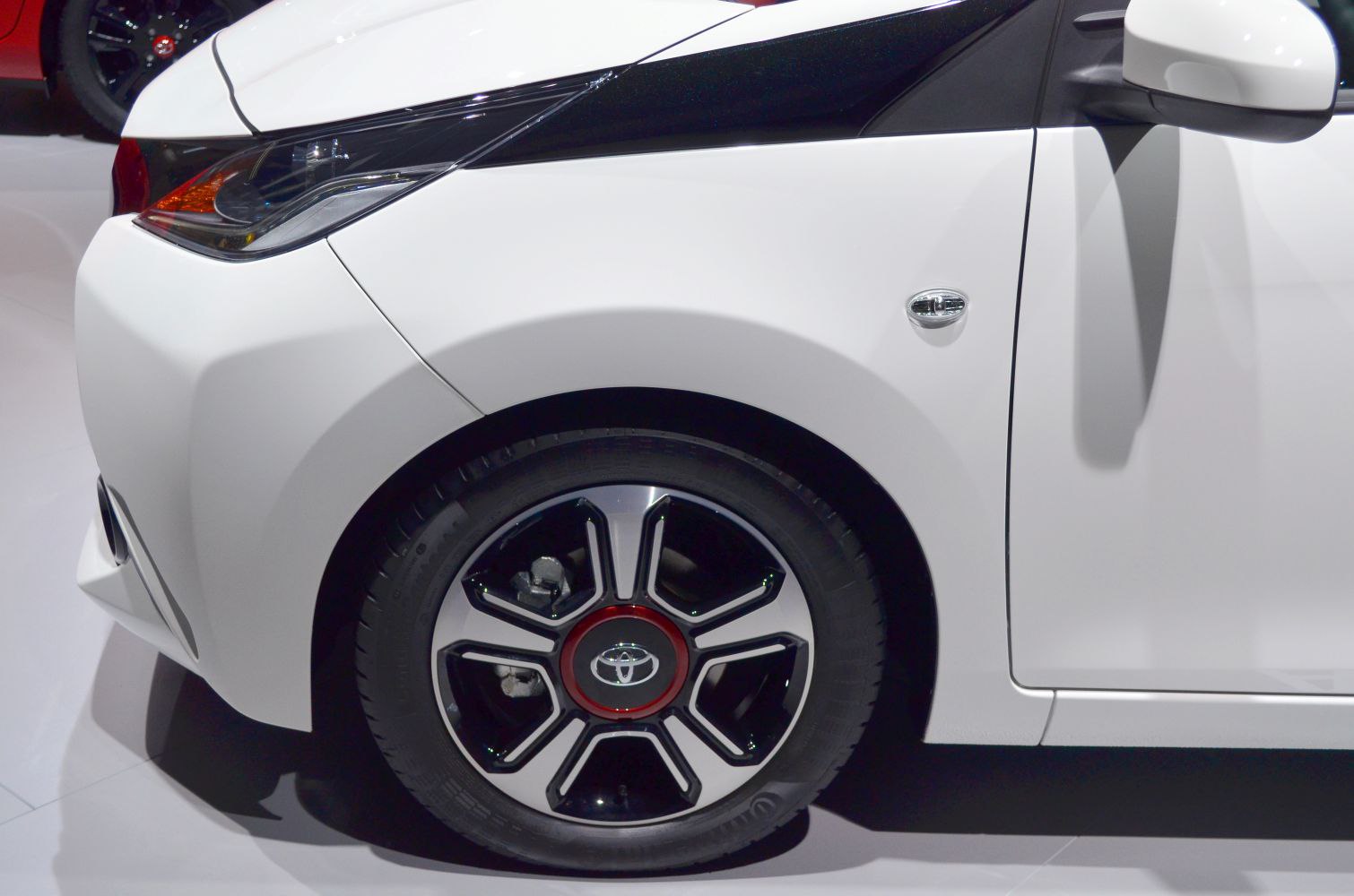Close-up of front wheel, side mirror, and headlight design