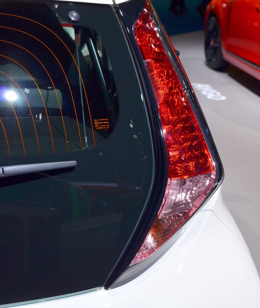 Close-up of a hatchback rear tail light and rear window with defroster lines