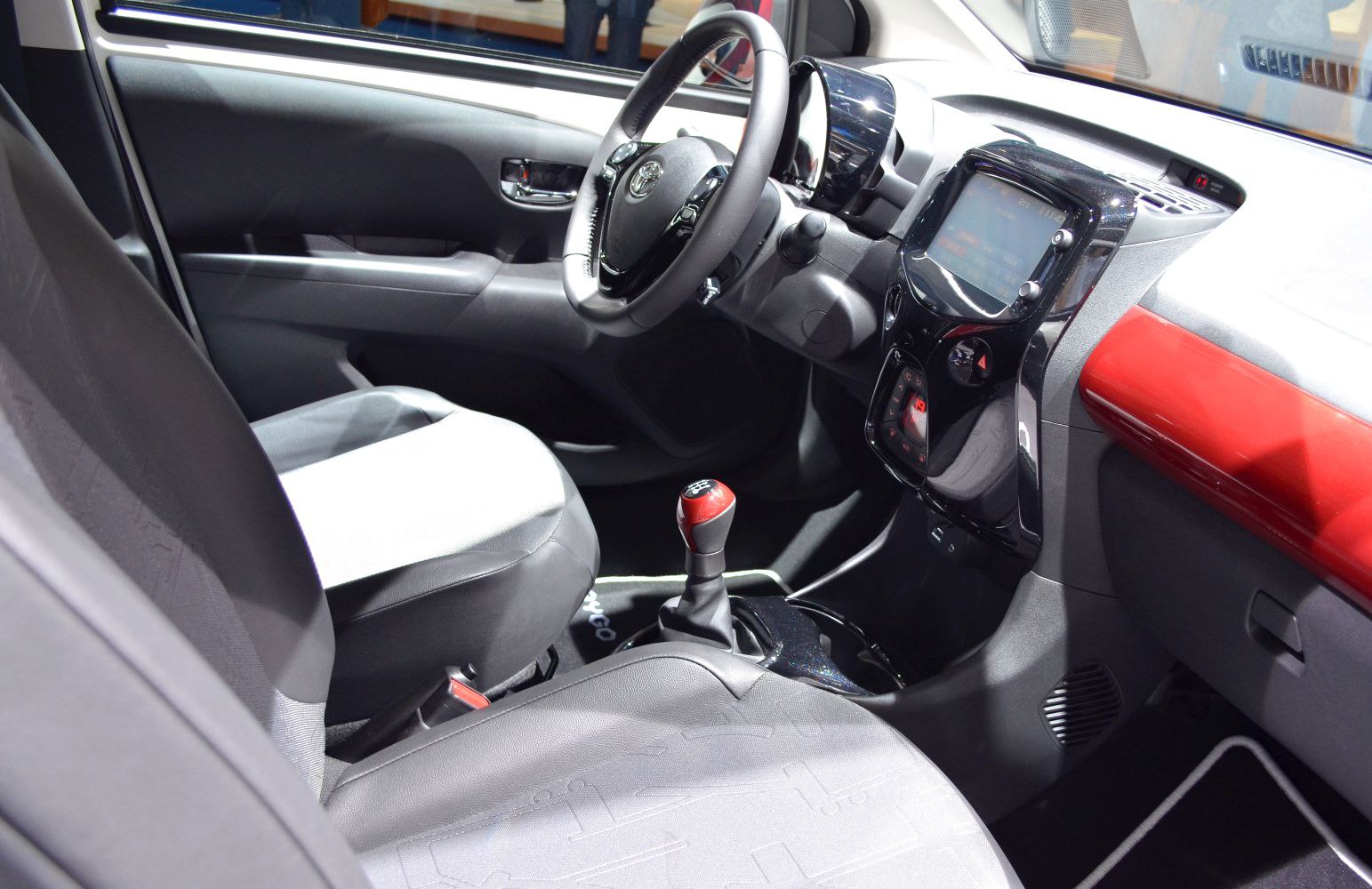 Compact car interior with manual gear shift and modern dashboard features