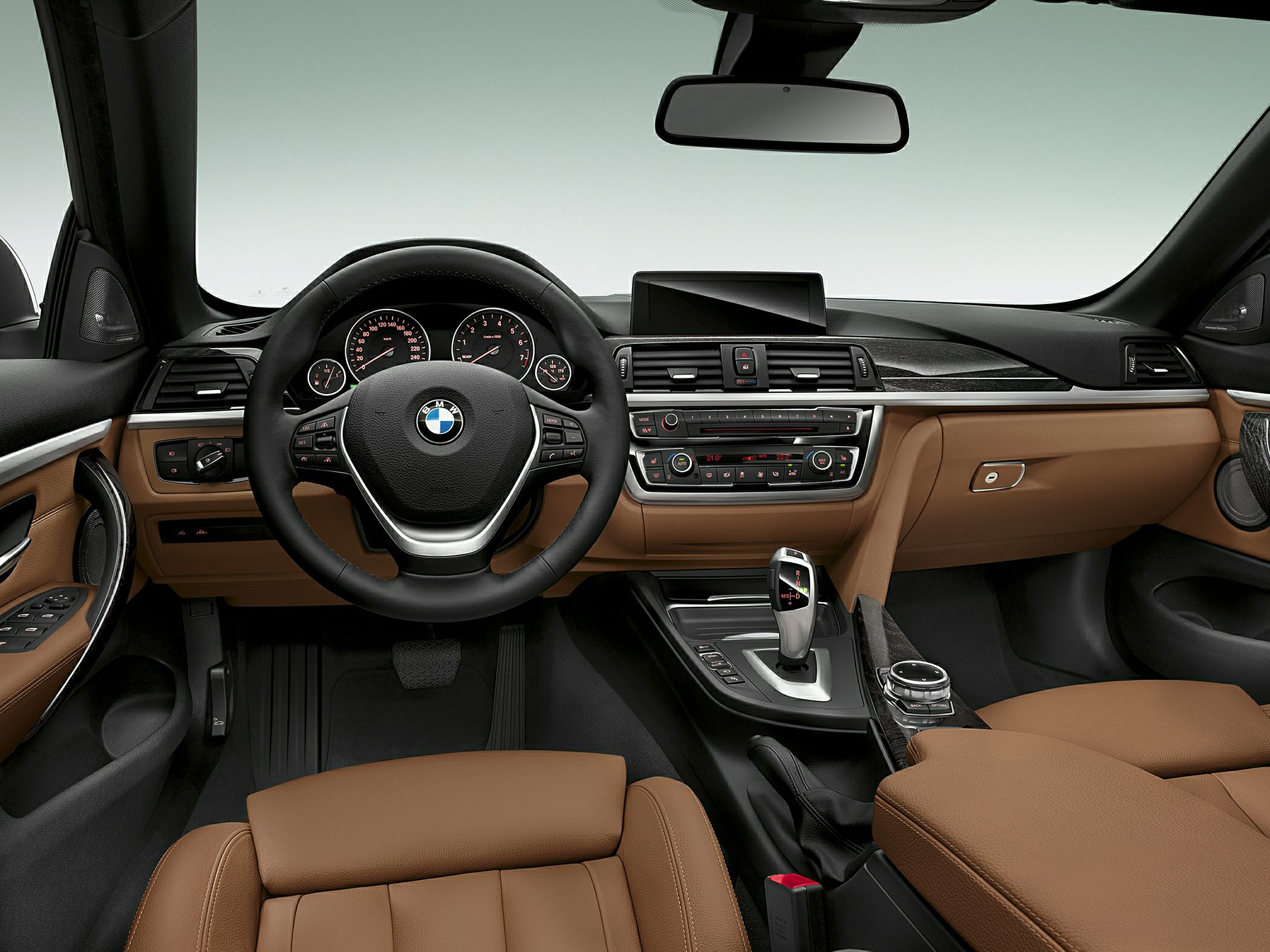 Modern car interior with dashboard, steering wheel, and brown leather seats