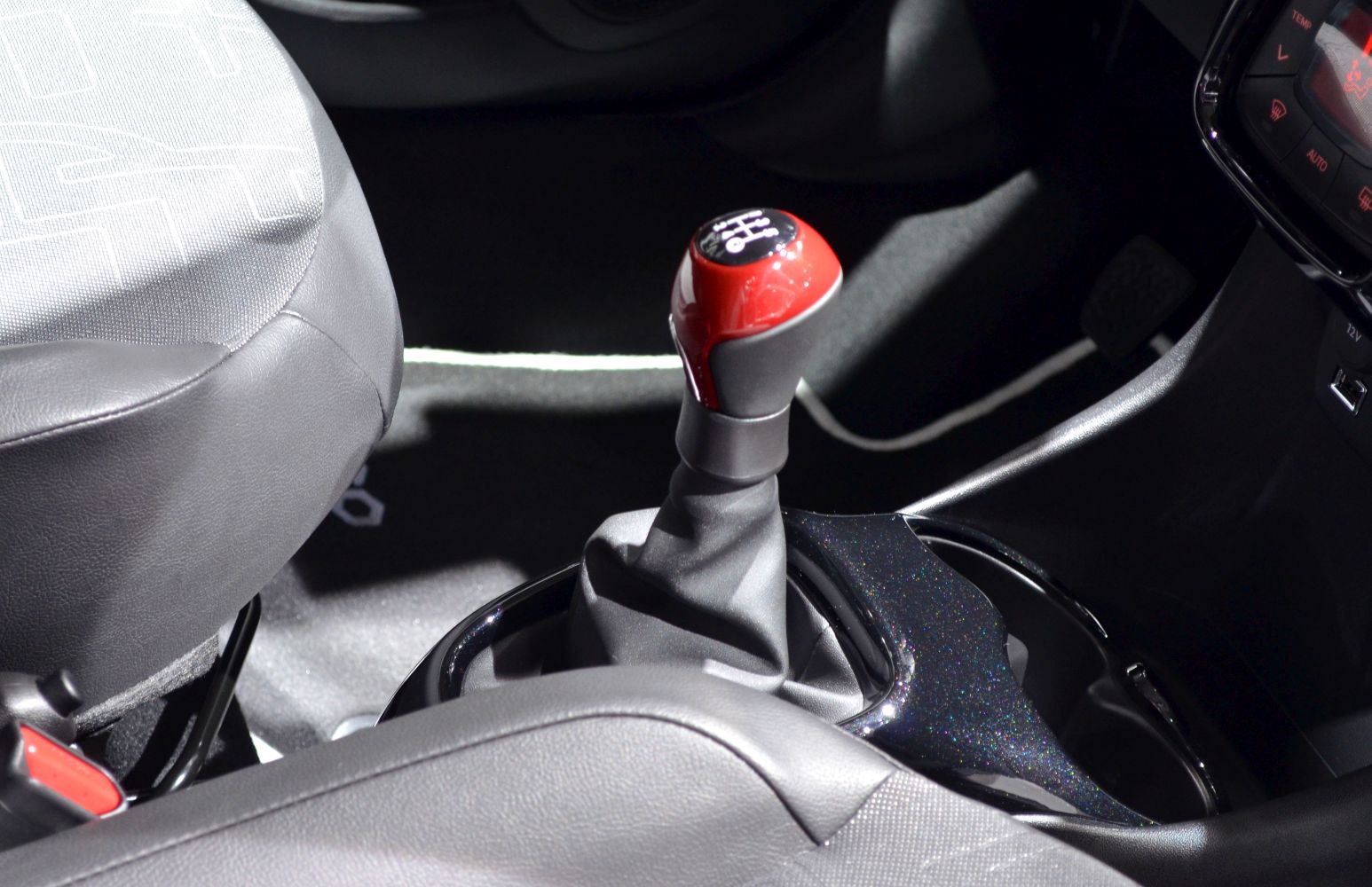Red gear stick manual transmission shift lever in car interior