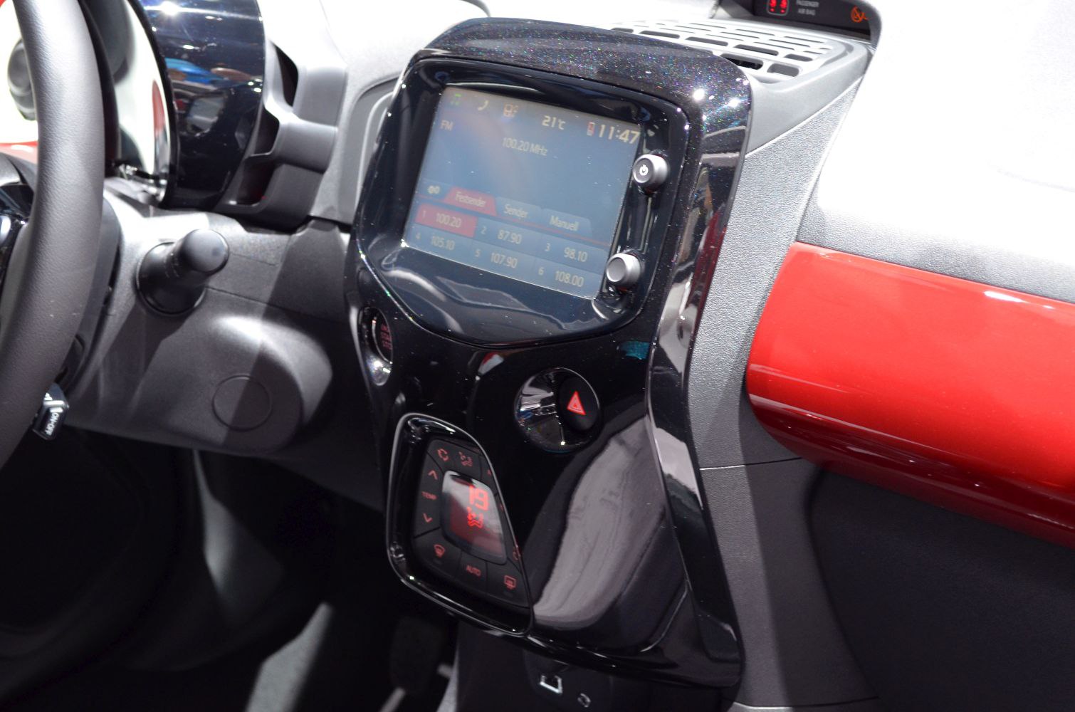 Touchscreen infotainment and climate control console with hazard button