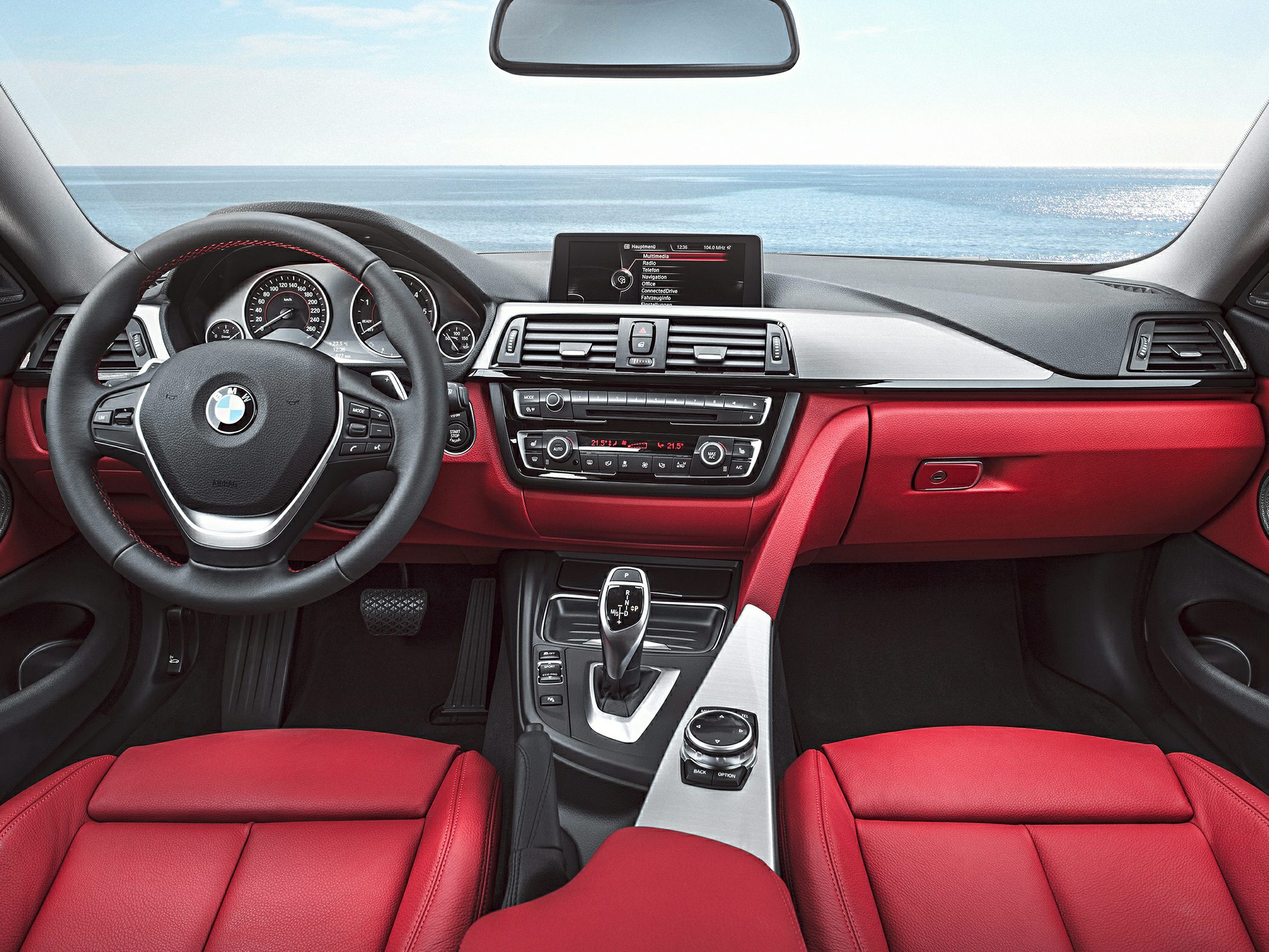 Red leather seats and modern BMW dashboard interior