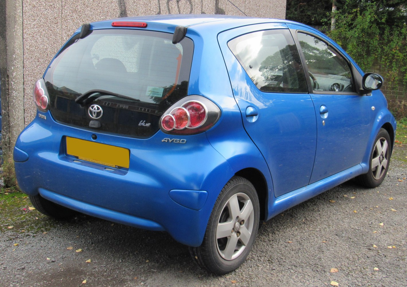 Compact hatchback rear view with distinctive tail lights and black rear hatch panel