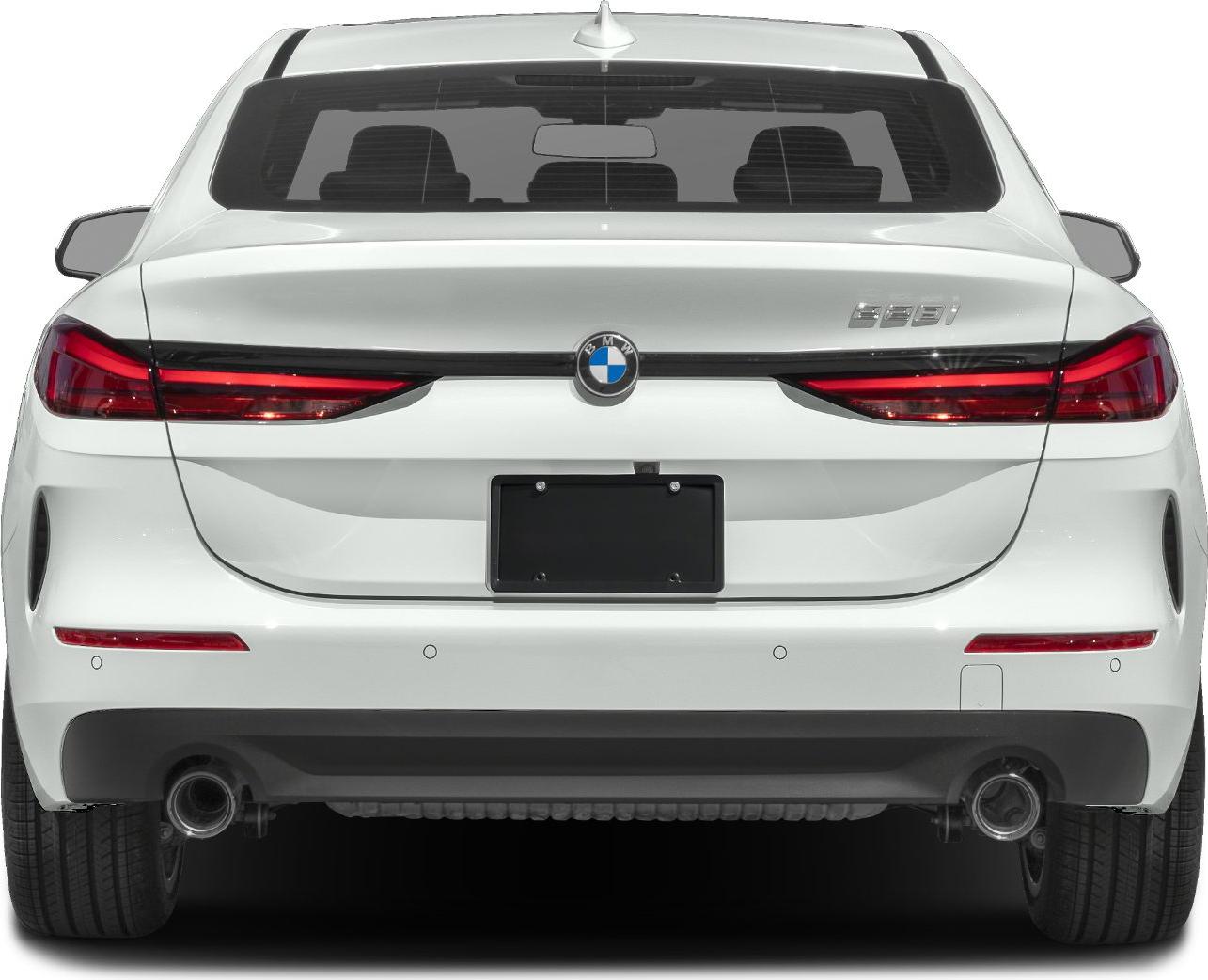 Rear view with sleek taillights and dual exhaust of white coupe sedan