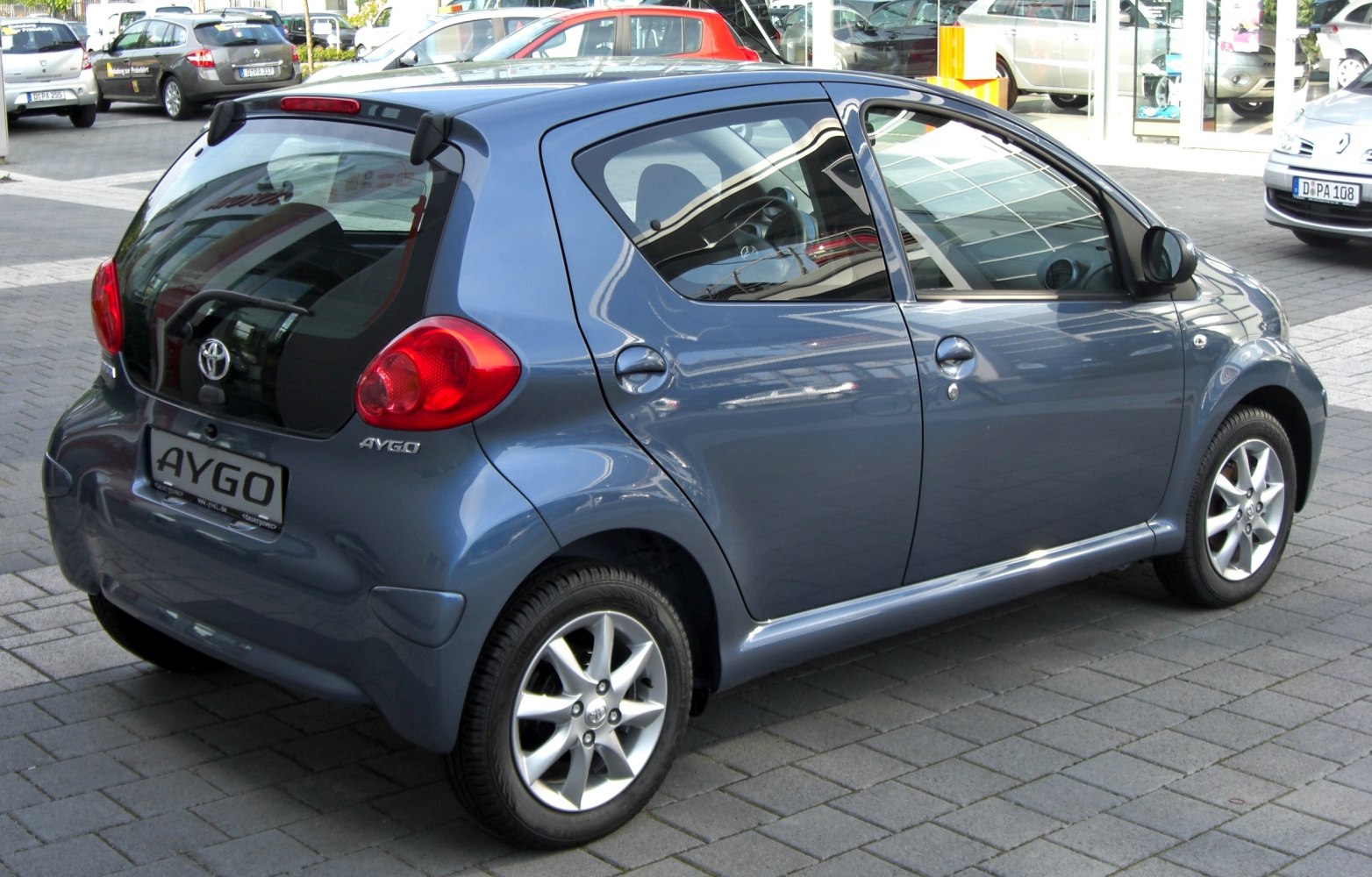 Compact hatchback rear-side with distinct taillights and alloy wheels