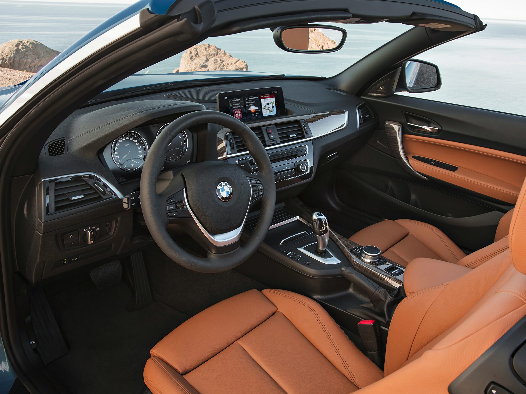 Convertible luxury car interior with modern dashboard and premium leather seats