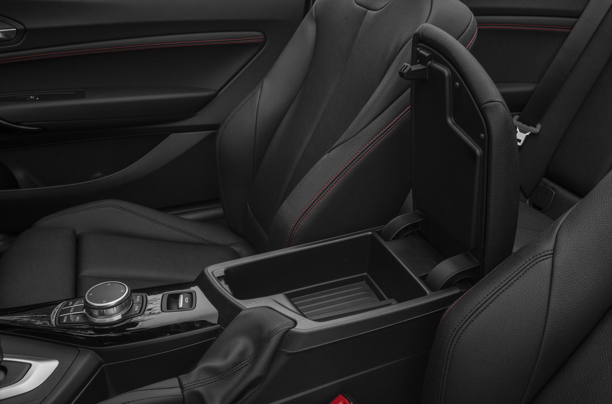 Interior center console storage and control dial with leather seats.
