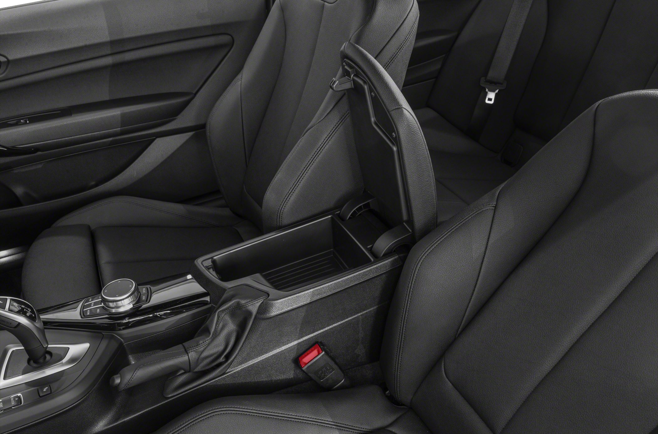 Open center console storage, black leather front seats, gear selector