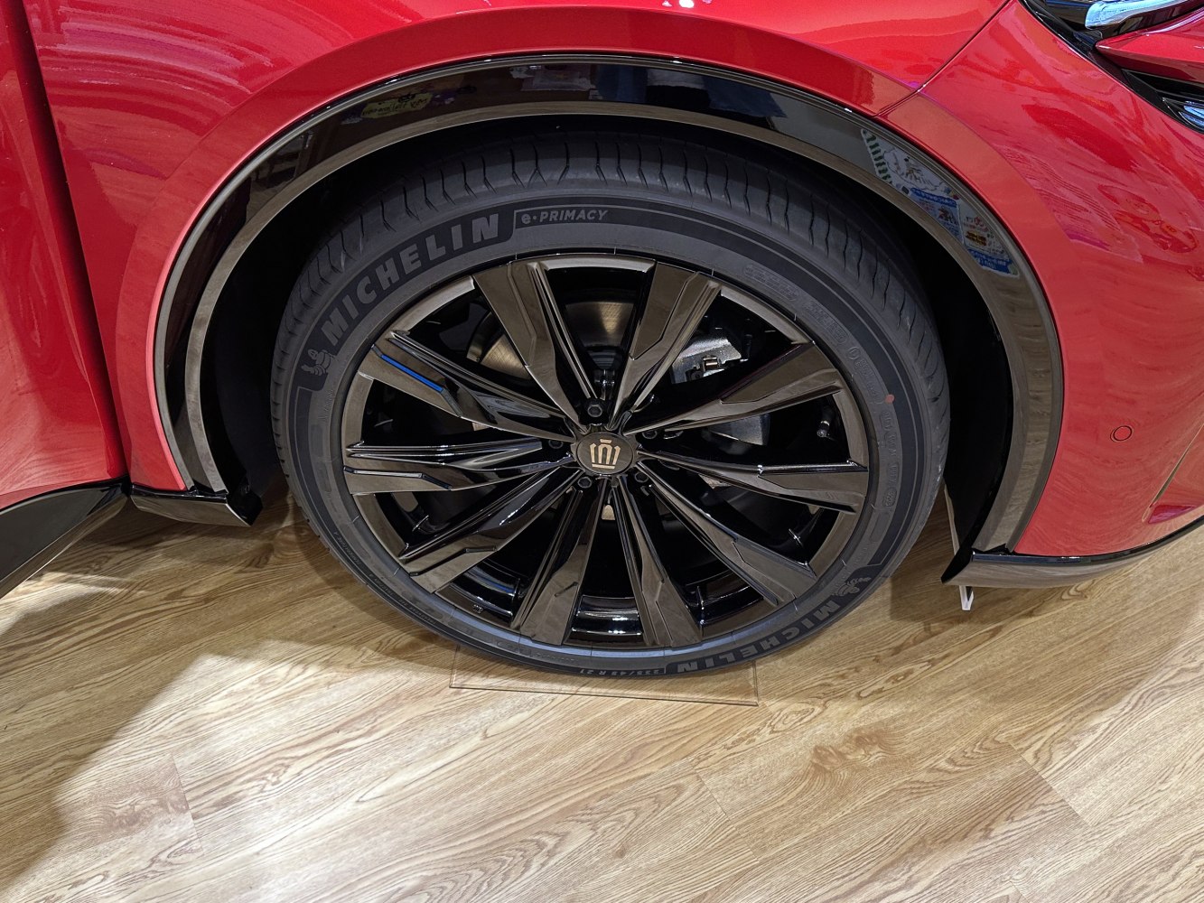 Glossy black multi-spoke alloy wheel with Michelin tire